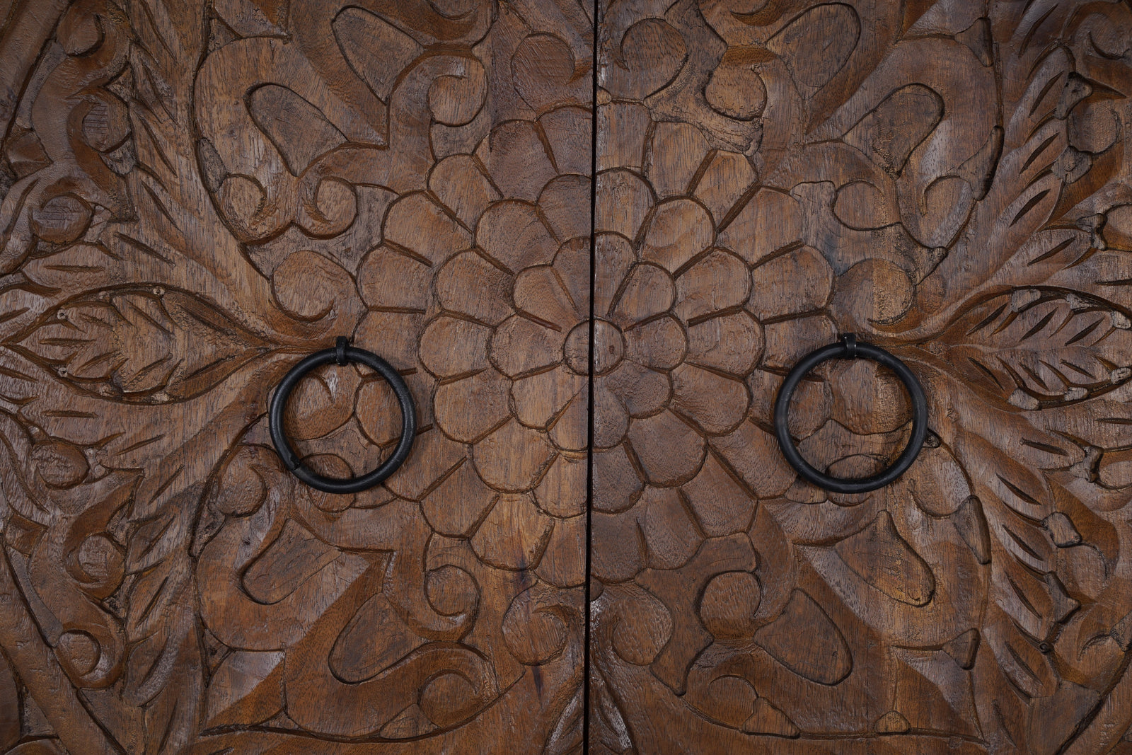 Close-up of solid mango wood grain showing natural golden tones and unique character marks on a handcrafted sideboard